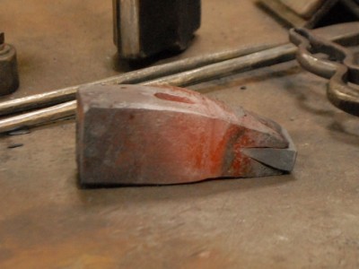 Here a thick wedge of high-carbon steel has been fitted into the cleft.  It's important for it to be flush with the hammer body on the sides before welding.