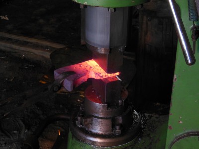 Shaping the blade on the power hammer.