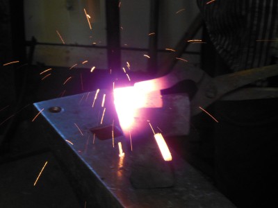 The upper edge of the plate is tack-welded to the poll of the axe.